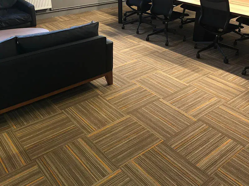 How should the colour and texture integrity of the office carpet be