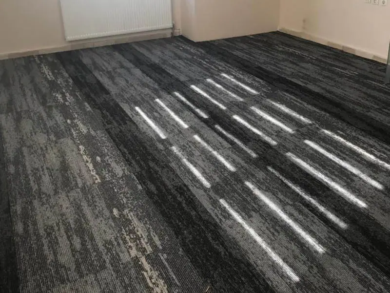How should the colour and texture integrity of the office carpet be